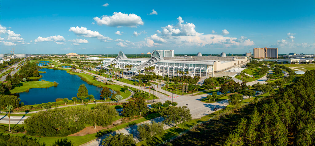 Aerial view of the Orange County Convention Center in Orlando, Florida, surrounded by lakes and greenery.