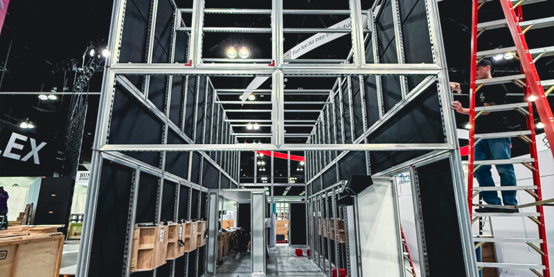 Steel booth framework under construction with ladders around.