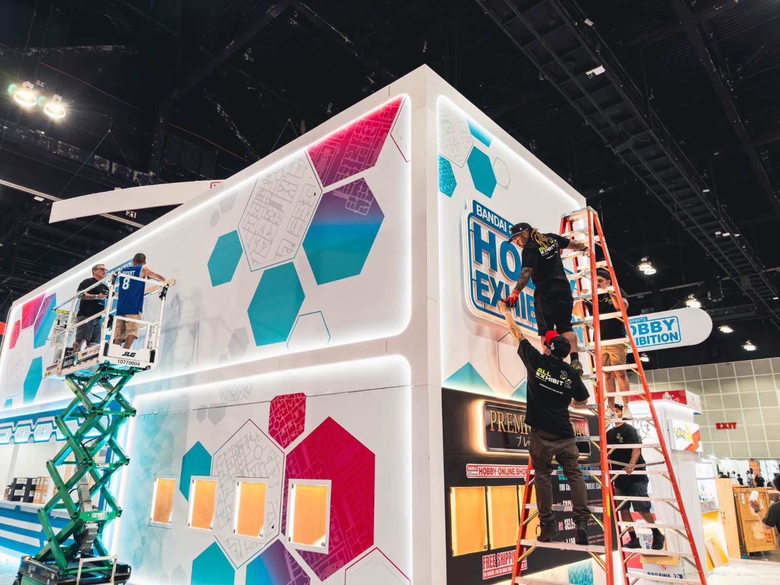 Crew installing a double-deck trade show booth