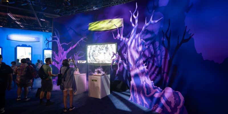 Scenic villains environment with display cases and screens inside the Walt Disney Imagineering pavilion