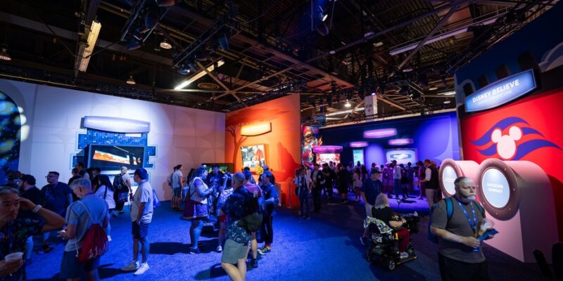 Guests in a themed zone of the Walt Disney Imagineering pavilion at D23 2026, Anaheim Convention Center