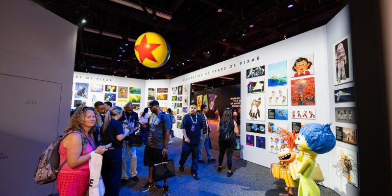 Guests in the original concept and production art gallery inside the Pixar anniversary pavilion