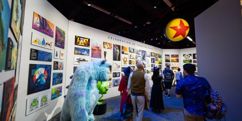 Framed art wall and a character statue inside the Pixar 40th anniversary pavilion